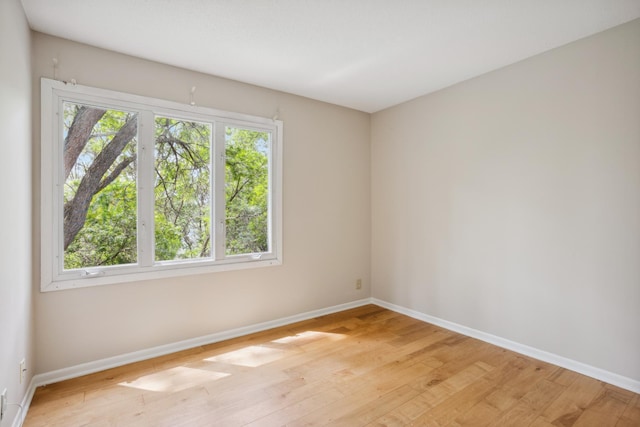 4854 Grenwich Trl N, Oakdale, MN 55128 - unfurnished room featuring baseboards and light wood-style flooring