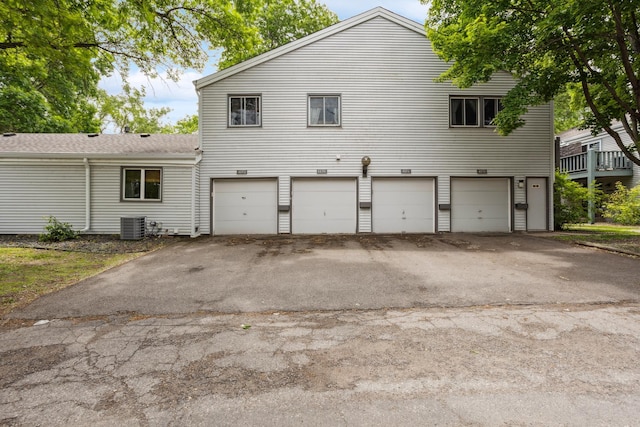 4854 Grenwich Trl N, Oakdale, MN 55128 - back of house featuring an attached garage and asphalt driveway