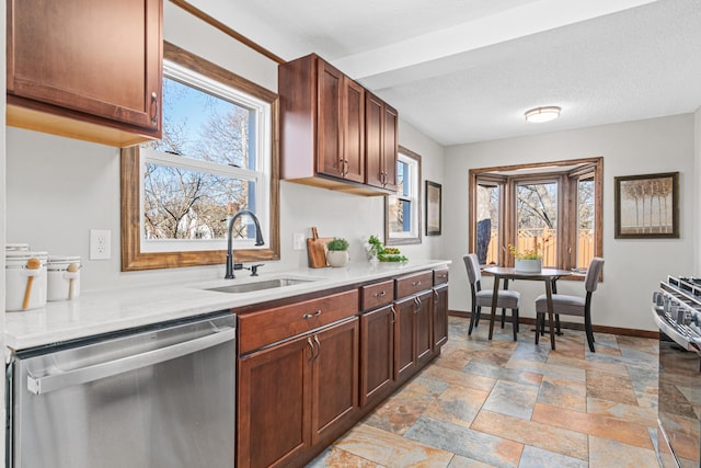6524 Minnetonka Blvd, Saint Louis Park, MN 55426 - kitchen with stainless steel appliances, a sink, baseboards, light countertops, and stone tile flooring