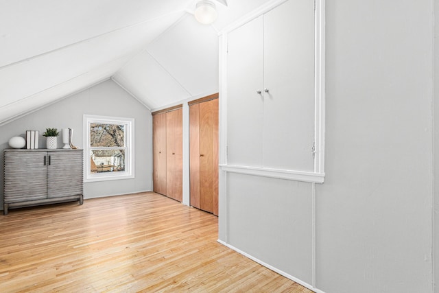 6524 Minnetonka Blvd, Saint Louis Park, MN 55426 - unfurnished bedroom with light wood-style flooring, lofted ceiling, and two closets