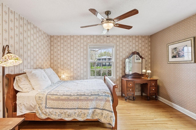 bedroom featuring wood finished floors and baseboards
