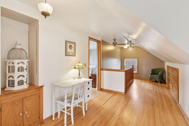 additional living space featuring lofted ceiling and light wood-style flooring