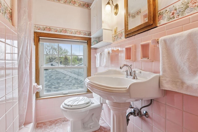 full bath with tile walls and toilet