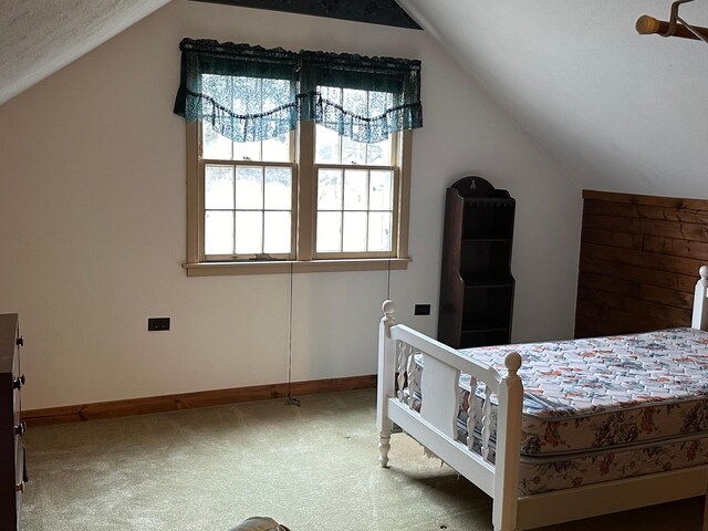 bedroom with baseboards, carpet, and vaulted ceiling