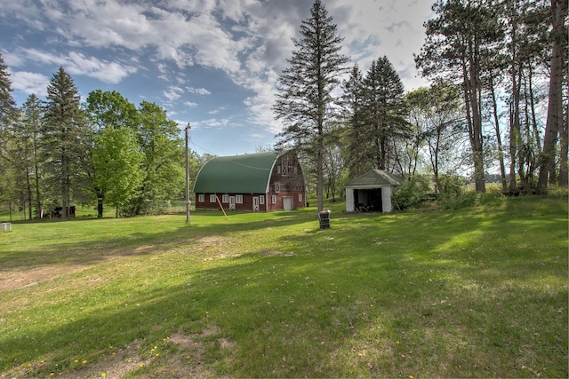 35449 Hastings St NE, Cambridge, MN 55008 - view of green lawn with a barn, an outdoor structure, and a garage