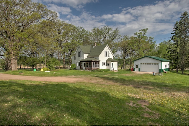 35449 Hastings St NE, Cambridge, MN 55008 - view of front of property with a garage, an outbuilding, a front yard, view of wooded area, and a chimney
