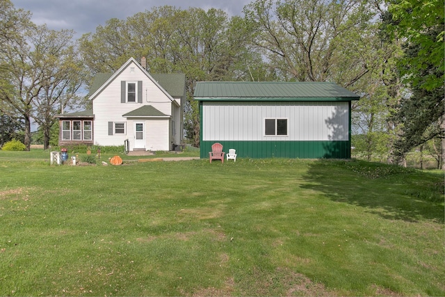 35449 Hastings St NE, Cambridge, MN 55008 - view of front facade with a front lawn, metal roof, and a sunroom