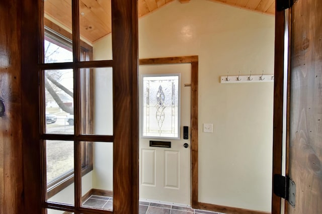 doorway featuring baseboards, tile patterned floors, wood ceiling, and vaulted ceiling