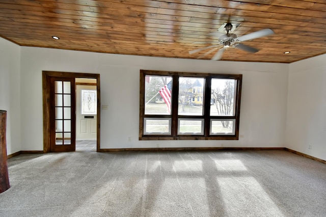 spare room with wood ceiling, a ceiling fan, and carpet
