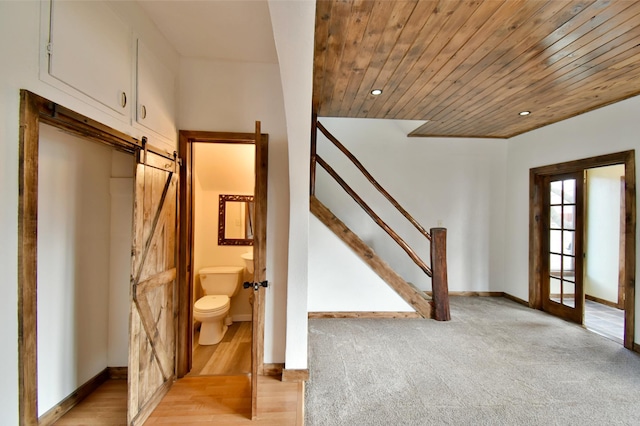 interior space featuring baseboards, recessed lighting, a barn door, and wood ceiling