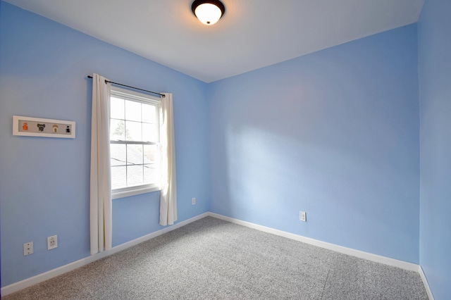 unfurnished room featuring baseboards and carpet floors