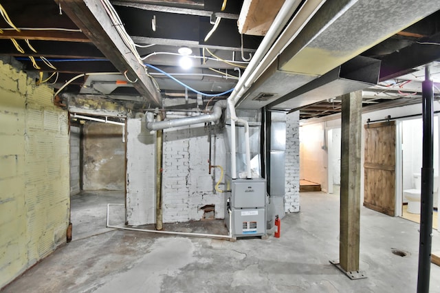 unfinished basement featuring visible vents and heating unit