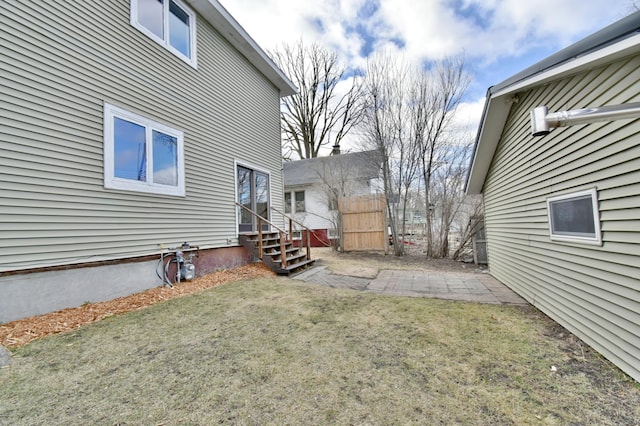 view of yard featuring entry steps and fence