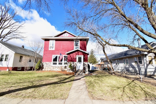 view of front of home featuring stone siding and a front lawn