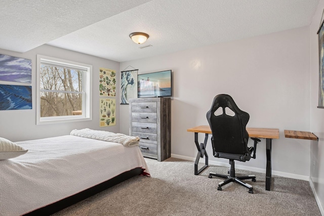 carpeted bedroom featuring baseboards and a textured ceiling