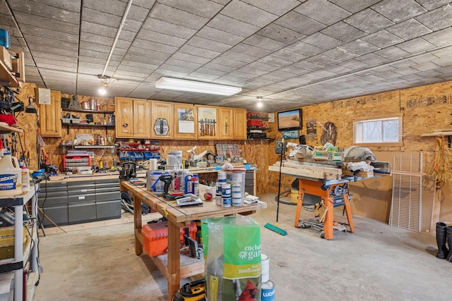 interior space featuring concrete flooring and a workshop area