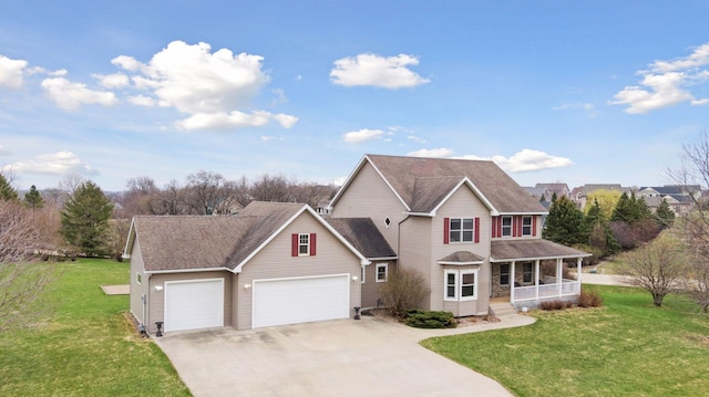 view of front facade with a front lawn, driveway, a porch, and an attached garage