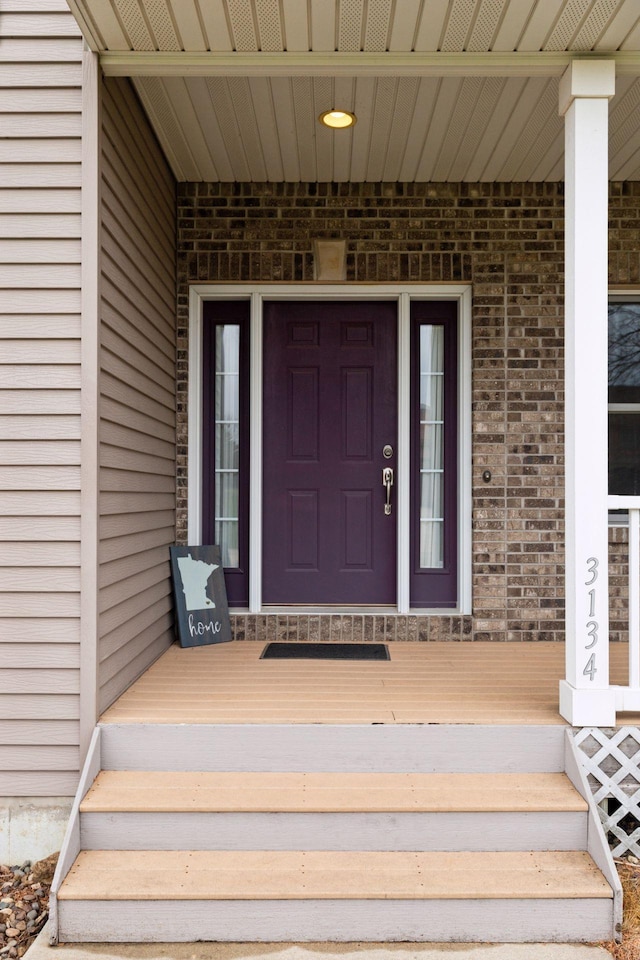 property entrance with brick siding