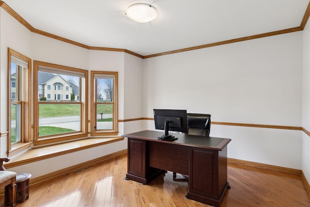 office area featuring light wood-type flooring, baseboards, and ornamental molding