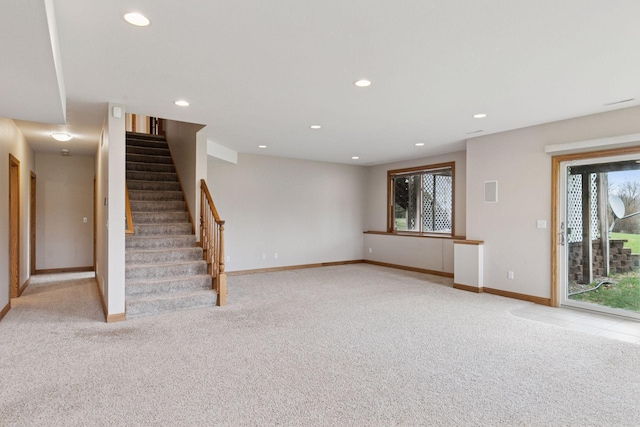 unfurnished living room featuring recessed lighting, stairs, baseboards, and light carpet