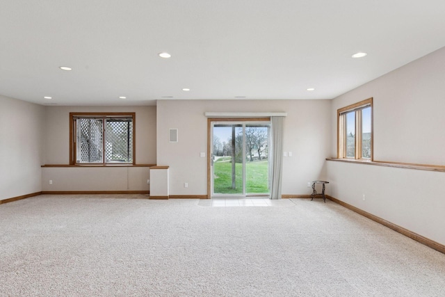 unfurnished room featuring light carpet, baseboards, and recessed lighting