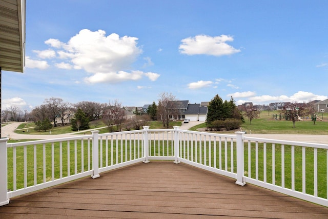 wooden terrace featuring a yard and a residential view