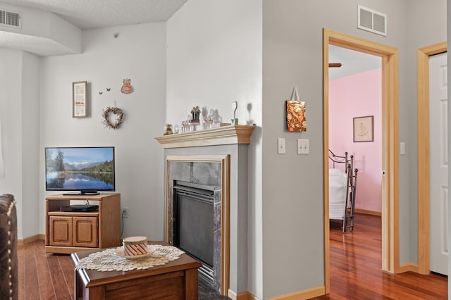 3600 Wooddale Ave S Unit 305, Saint Louis Park, MN 55416 - living area featuring baseboards, visible vents, a glass covered fireplace, and dark wood-style flooring