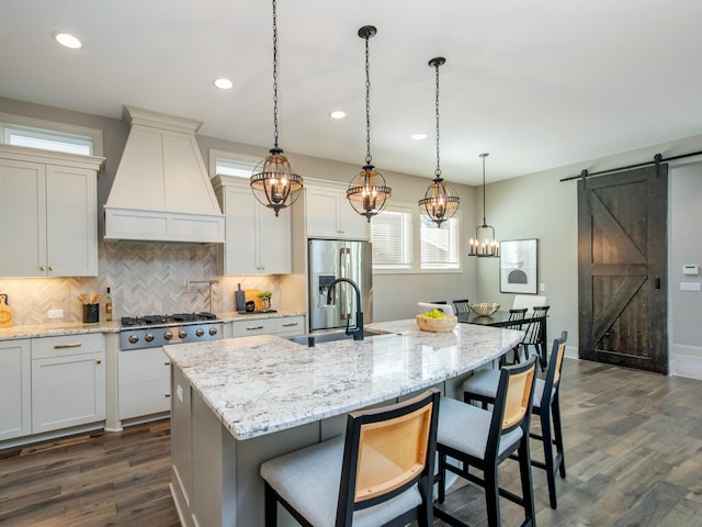 2728 Chowen Ave S, Minneapolis, MN 55416 - kitchen featuring a barn door, a sink, stainless steel appliances, custom range hood, and backsplash