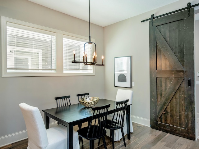 2728 Chowen Ave S, Minneapolis, MN 55416 - dining space featuring baseboards, a barn door, wood finished floors, and a chandelier