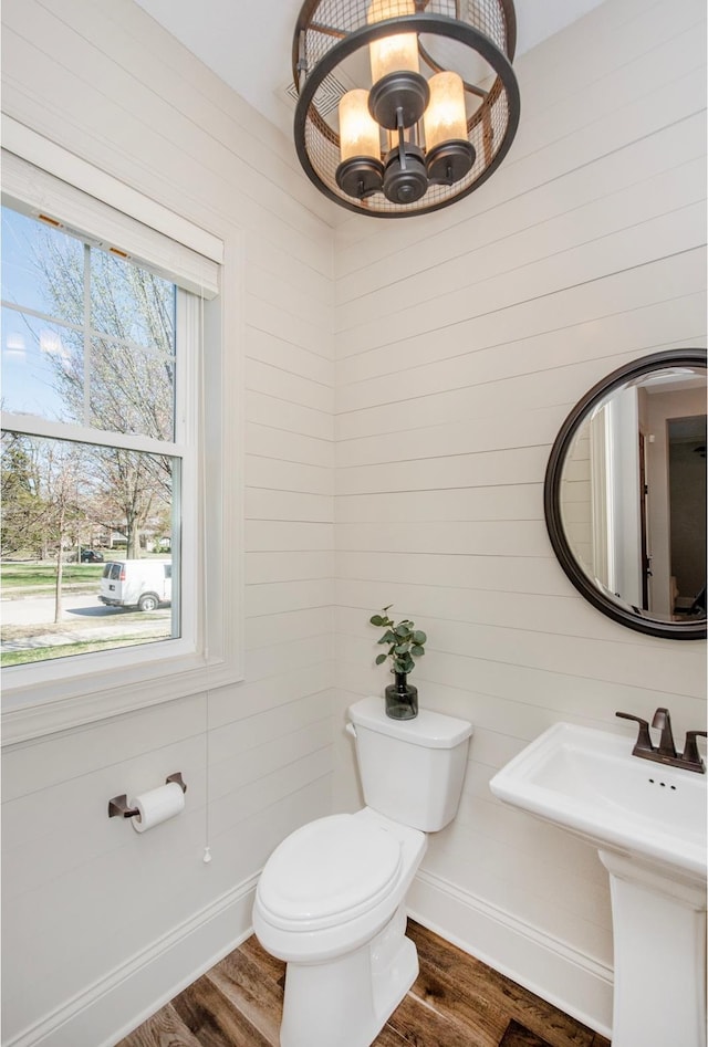 2728 Chowen Ave S, Minneapolis, MN 55416 - bathroom featuring an inviting chandelier, baseboards, wood finished floors, and toilet