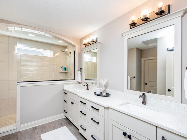 2728 Chowen Ave S, Minneapolis, MN 55416 - bathroom featuring a sink, a walk in shower, double vanity, and wood finished floors