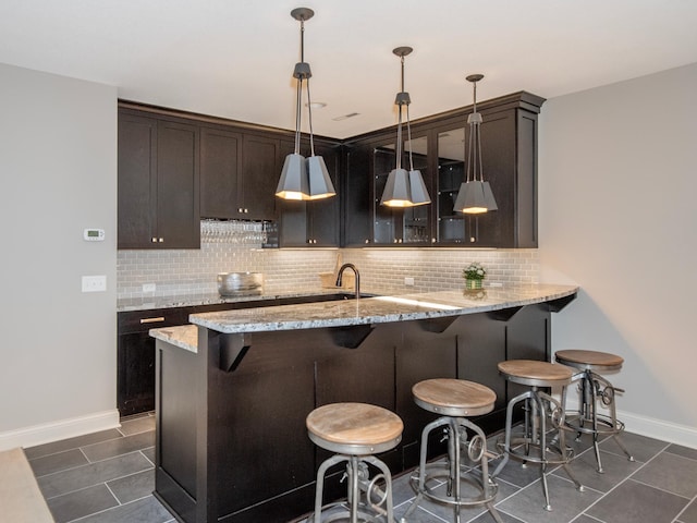 2728 Chowen Ave S, Minneapolis, MN 55416 - kitchen with a breakfast bar area, dark brown cabinetry, glass insert cabinets, and tasteful backsplash