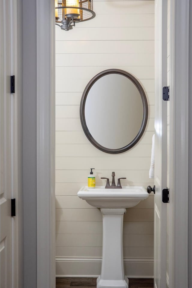 2728 Chowen Ave S, Minneapolis, MN 55416 - bathroom with baseboards, wood finished floors, and wooden walls