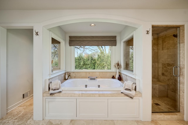 full bathroom with a stall shower, a garden tub, and visible vents
