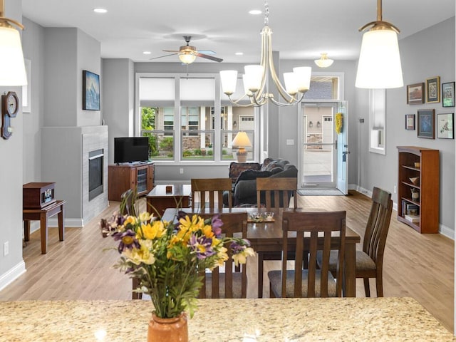 1128 Willowbrook Cir, Delano, MN 55328 - dining space featuring light wood-type flooring, a fireplace, ceiling fan, baseboards, and recessed lighting