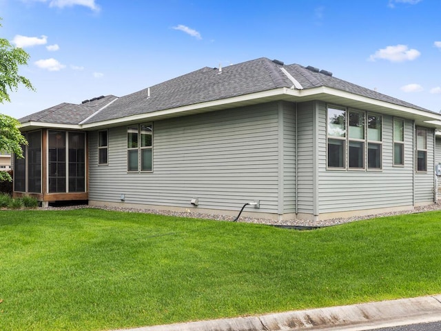 1128 Willowbrook Cir, Delano, MN 55328 - view of home's exterior featuring a lawn, a sunroom, and a shingled roof