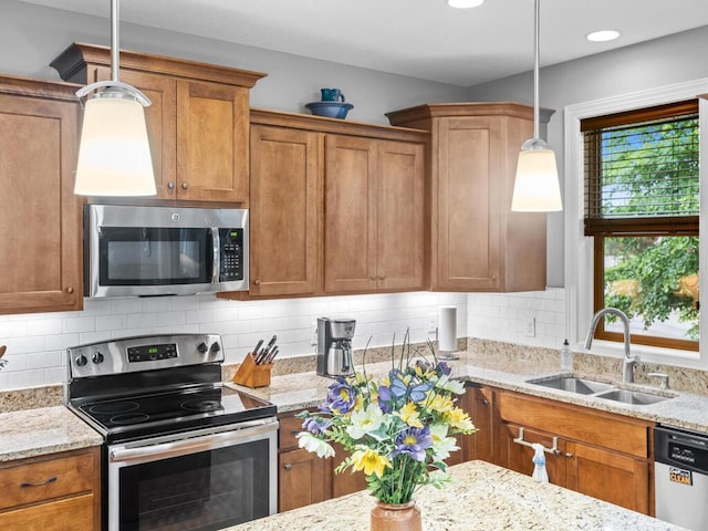 1128 Willowbrook Cir, Delano, MN 55328 - kitchen with appliances with stainless steel finishes, a sink, brown cabinets, and light stone counters