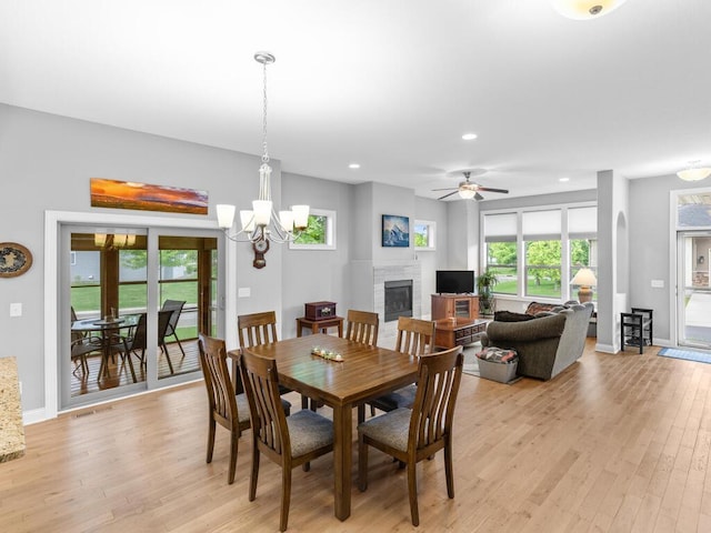 1128 Willowbrook Cir, Delano, MN 55328 - dining room with a fireplace, light wood-type flooring, recessed lighting, a chandelier, and baseboards