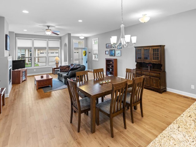 1128 Willowbrook Cir, Delano, MN 55328 - dining space featuring light wood-style floors, a chandelier, baseboards, a ceiling fan, and recessed lighting