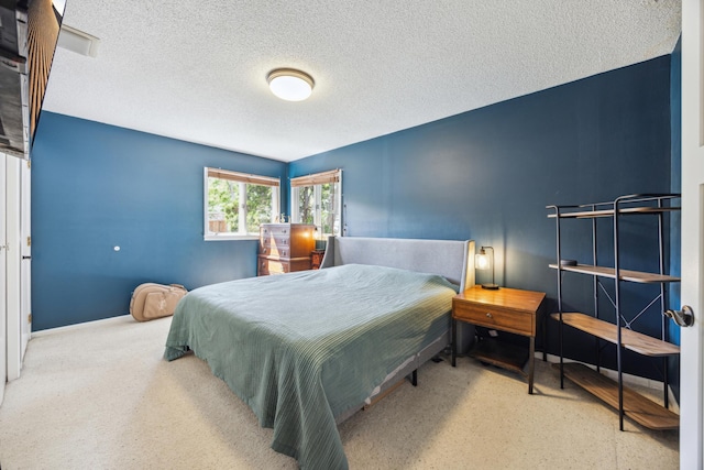 bedroom featuring a textured ceiling and baseboards