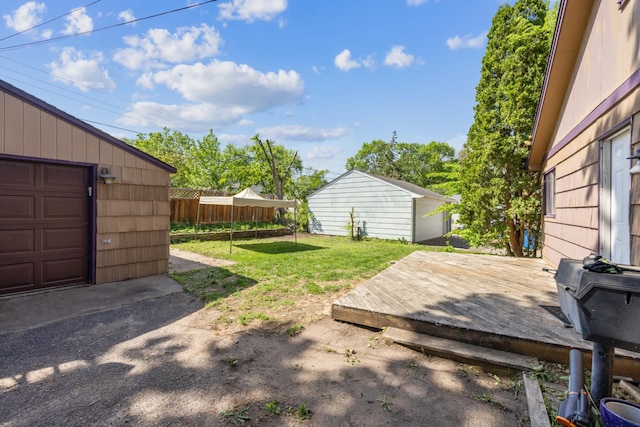 view of yard with a deck and an outdoor structure