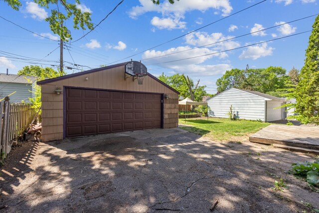 detached garage featuring fence