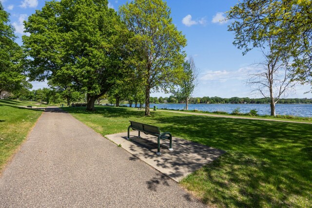 view of property's community featuring a yard and a water view