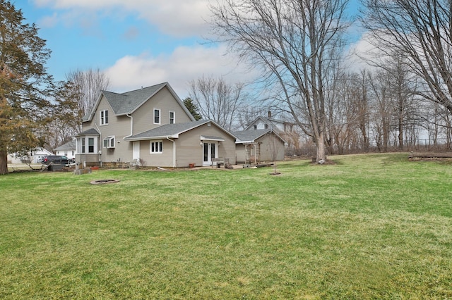 29058 132nd St, Waseca, MN 56093 - view of property exterior featuring a fire pit, a lawn, and a shingled roof