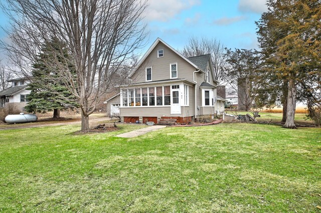 29058 132nd St, Waseca, MN 56093 - rear view of house with a sunroom, a lawn, and entry steps
