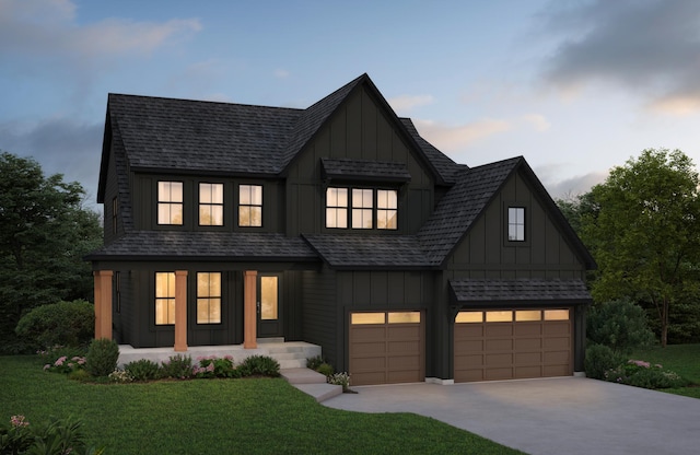 modern farmhouse style home with concrete driveway, a yard, board and batten siding, and a garage