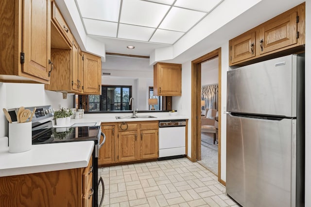 1235 Yale Pl Unit 207, Minneapolis, MN 55403 - kitchen featuring a sink, light countertops, brick patterned floor, brown cabinetry, and stainless steel appliances