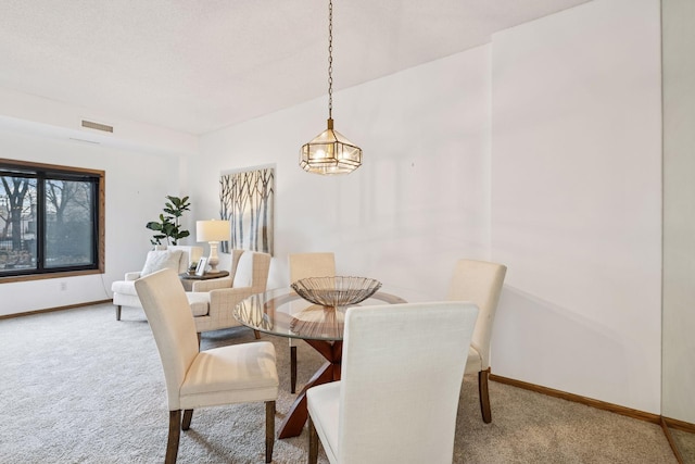 1235 Yale Pl Unit 207, Minneapolis, MN 55403 - dining space with baseboards, visible vents, and carpet