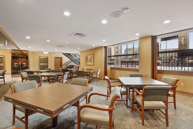 1235 Yale Pl Unit 207, Minneapolis, MN 55403 - dining space featuring visible vents, recessed lighting, stairs, and baseboards