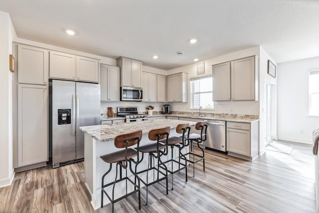 6432 Genevieve Trl S, Cottage Grove, MN 55016 - kitchen featuring gray cabinetry, appliances with stainless steel finishes, a center island, and light wood-style floors